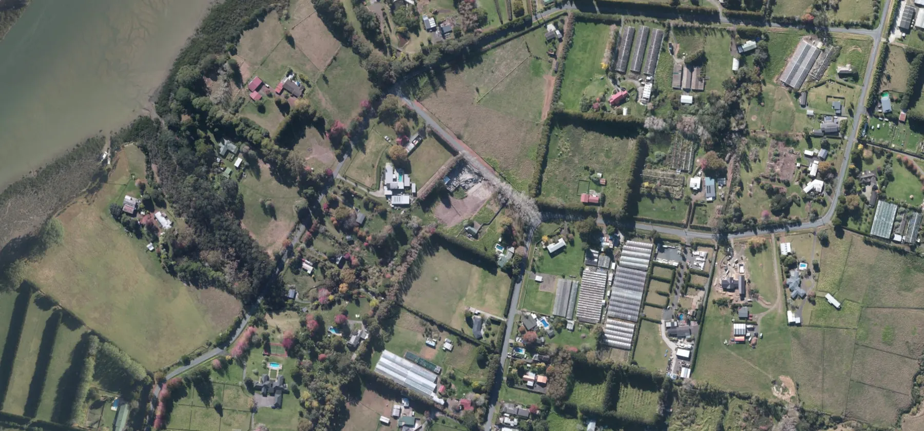 Wider aerial context around Riverlea Road, Whenuapai. Includes neighbouring properties; site boundaries are not shown.