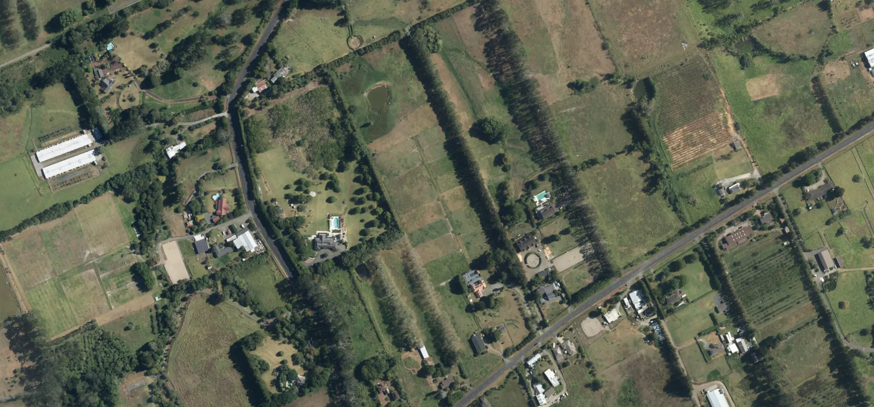 Wider aerial context around Tawa Road, Kumeū. Includes neighbouring properties; site boundaries are not shown.
